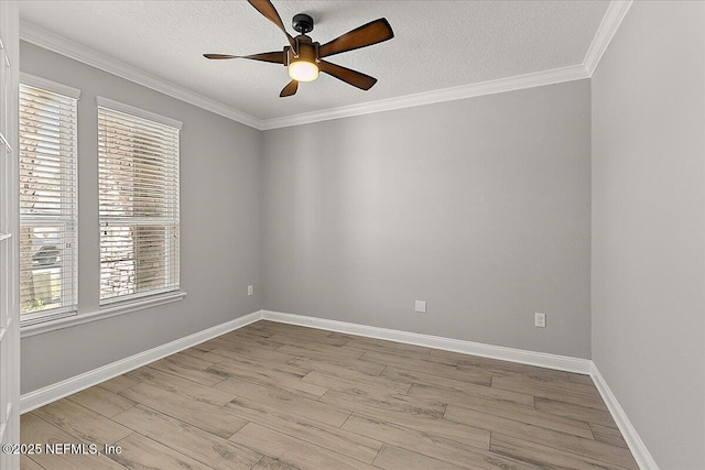 unfurnished room with baseboards, ceiling fan, wood finished floors, crown molding, and a textured ceiling