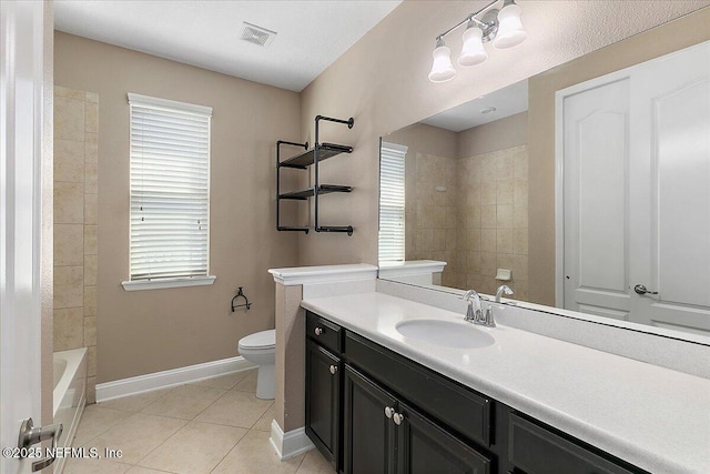 bathroom featuring toilet, vanity, baseboards, visible vents, and tile patterned floors