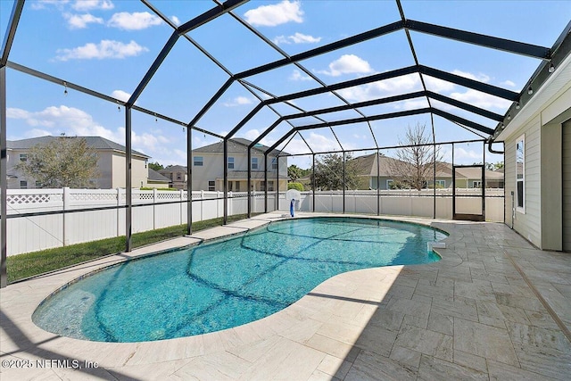 view of swimming pool with a fenced in pool, a patio, glass enclosure, fence, and a residential view