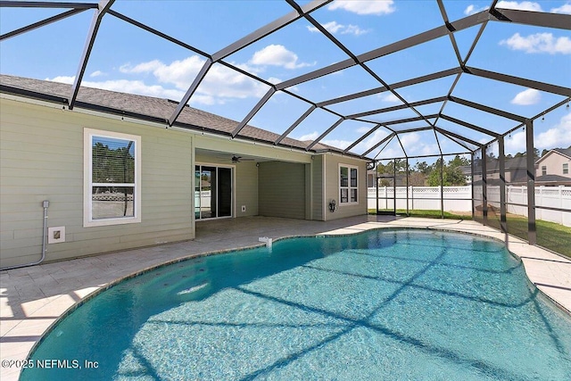 view of pool featuring a fenced in pool, a patio, glass enclosure, ceiling fan, and fence