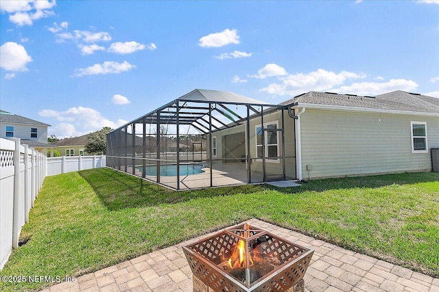 exterior space featuring a patio area, a fenced backyard, a yard, and a lanai