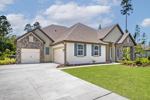 view of front of home with a garage, a shingled roof, stone siding, board and batten siding, and a front yard