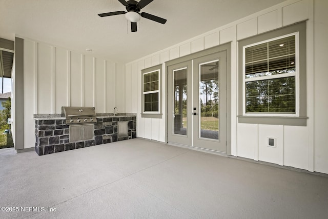 view of patio with area for grilling, a sink, a grill, a ceiling fan, and french doors