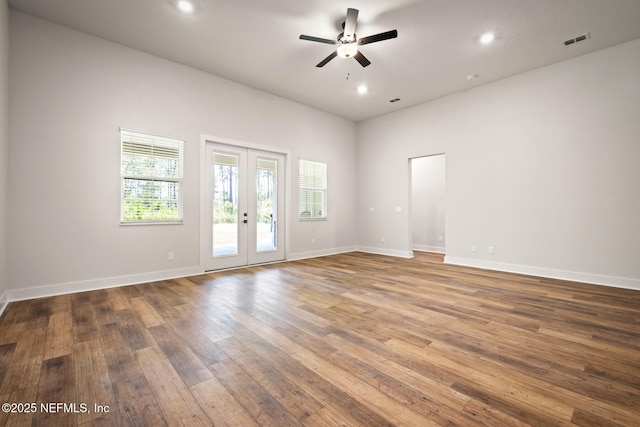 unfurnished room featuring french doors, visible vents, baseboards, and hardwood / wood-style flooring