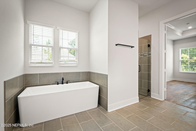 bathroom featuring a soaking tub, a shower stall, and tile patterned flooring