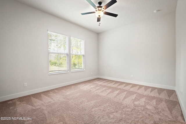 unfurnished room featuring baseboards and light colored carpet