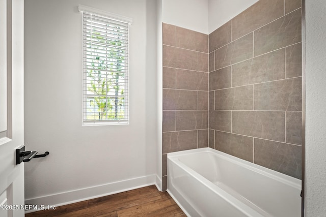 bathroom with wood finished floors and baseboards