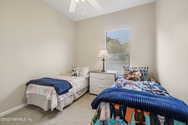 bedroom featuring a ceiling fan, light colored carpet, vaulted ceiling, and baseboards