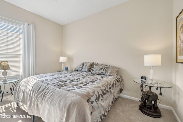 bedroom with carpet, lofted ceiling, and baseboards