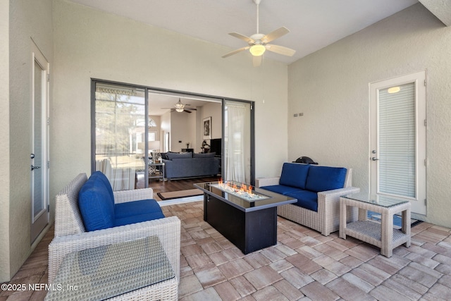 view of patio / terrace with an outdoor living space with a fire pit and a ceiling fan