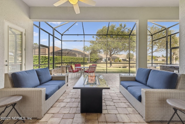 sunroom featuring a ceiling fan