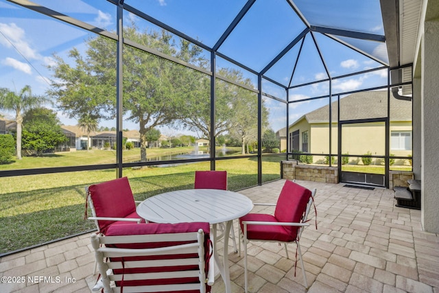 view of patio featuring glass enclosure and a residential view