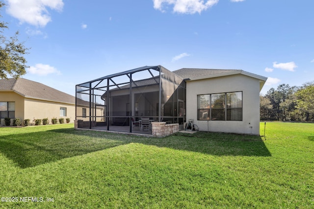 back of house featuring a lanai, a patio area, a lawn, and stucco siding