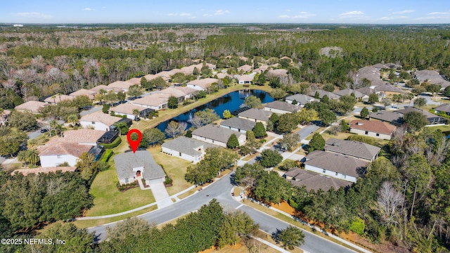 aerial view with a water view, a residential view, and a view of trees