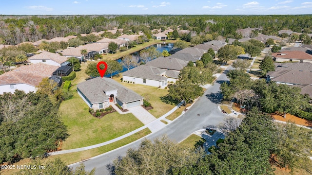 birds eye view of property featuring a water view and a residential view