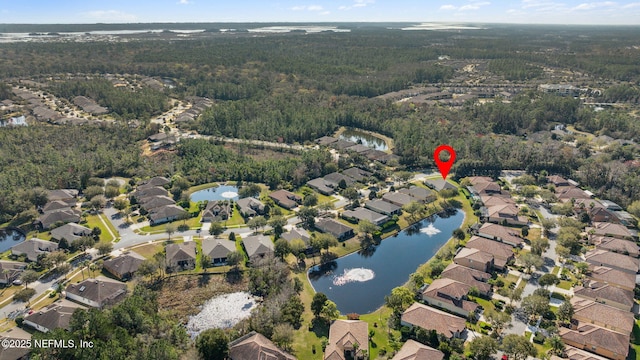 aerial view with a water view, a wooded view, and a residential view