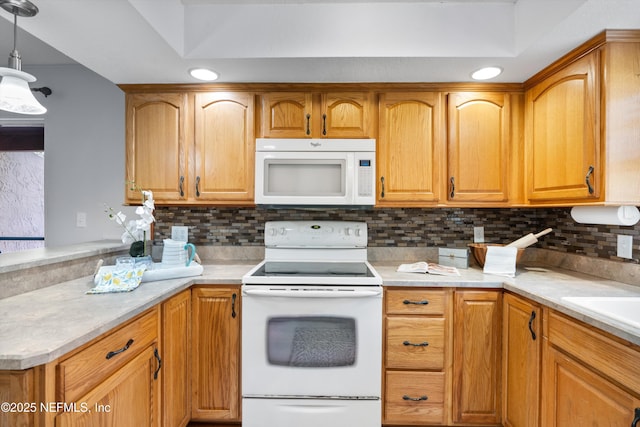 kitchen featuring white appliances, tasteful backsplash, and light countertops