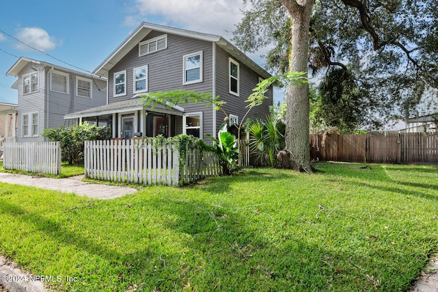 view of front of home with a fenced front yard and a front yard