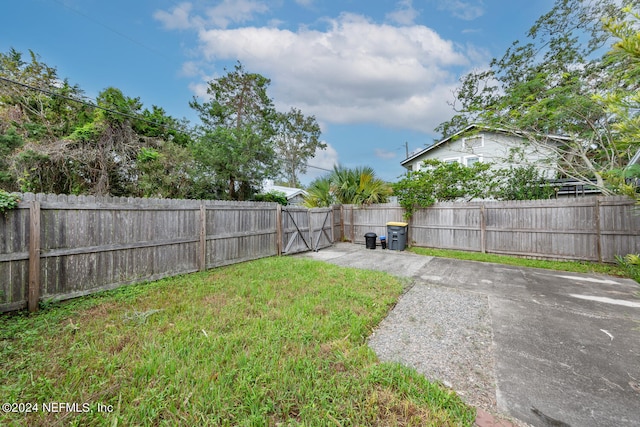 view of yard featuring a patio and a fenced backyard