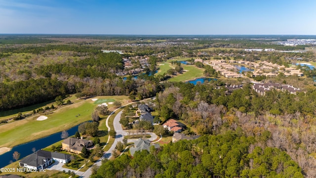 birds eye view of property featuring view of golf course, a water view, and a forest view