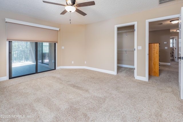 unfurnished bedroom featuring a textured ceiling, carpet, and baseboards