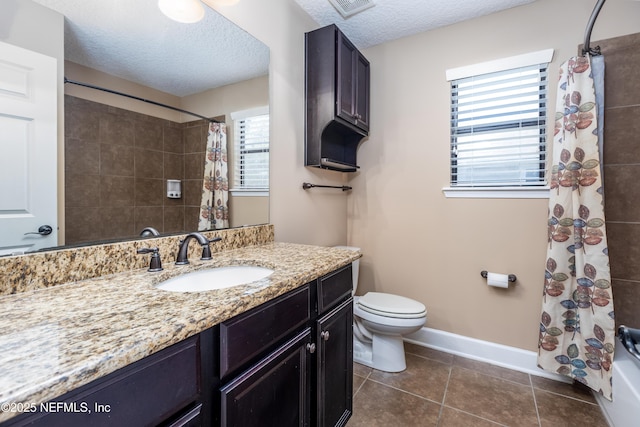 full bathroom with baseboards, toilet, tile patterned flooring, a textured ceiling, and vanity