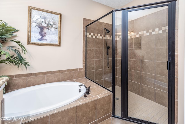 bathroom with a stall shower and a garden tub