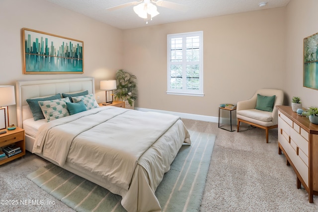 bedroom with a textured ceiling, ceiling fan, carpet, and baseboards