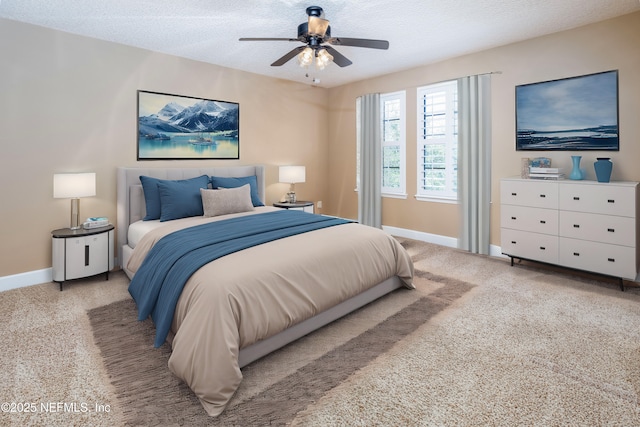 bedroom featuring a ceiling fan, baseboards, a textured ceiling, and carpet flooring