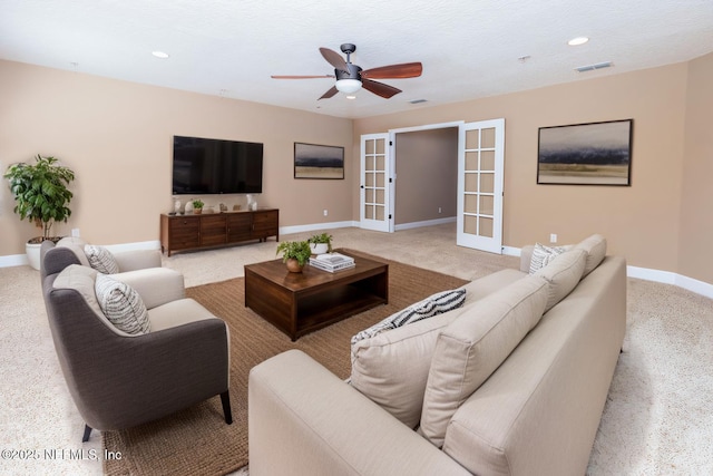 carpeted living area featuring baseboards, visible vents, a ceiling fan, french doors, and recessed lighting