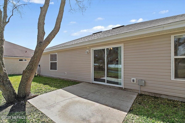 rear view of property featuring a patio and a yard