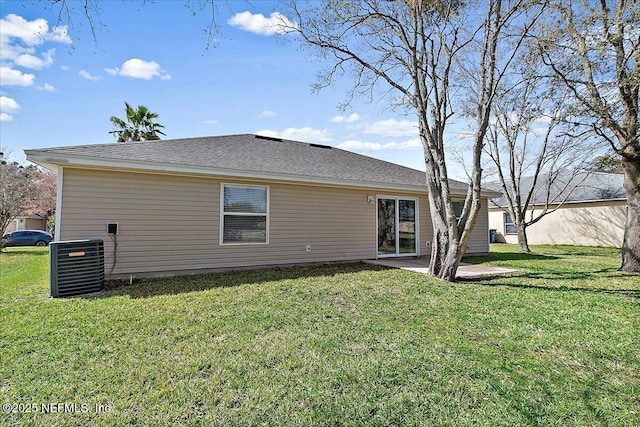 back of house featuring central air condition unit, a lawn, and a patio