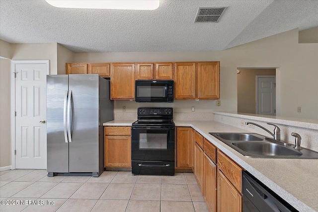 kitchen with black appliances, light tile patterned floors, visible vents, and a sink