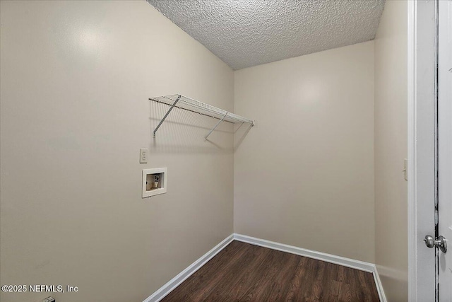 laundry area featuring washer hookup, laundry area, dark wood-style flooring, and baseboards