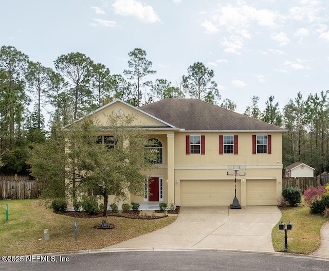 view of front of property with a garage, fence, and stucco siding