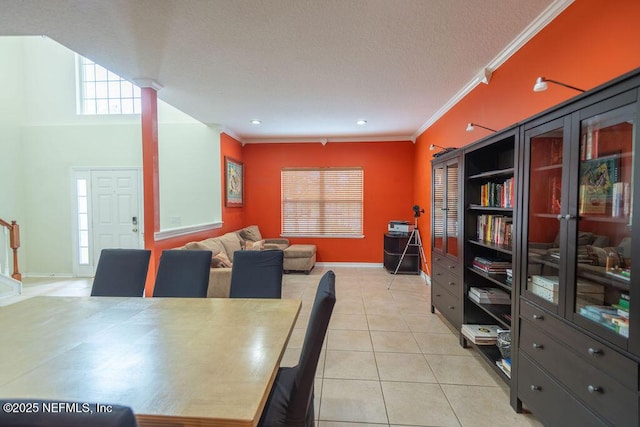 dining space featuring light tile patterned floors, ornamental molding, and baseboards