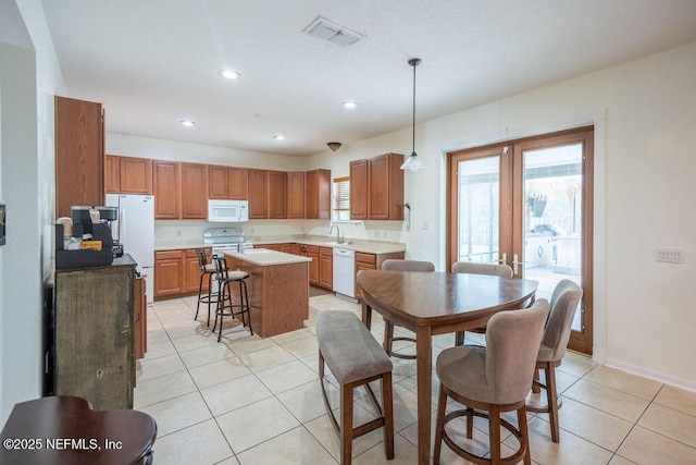 dining room with light tile patterned floors, baseboards, visible vents, french doors, and recessed lighting