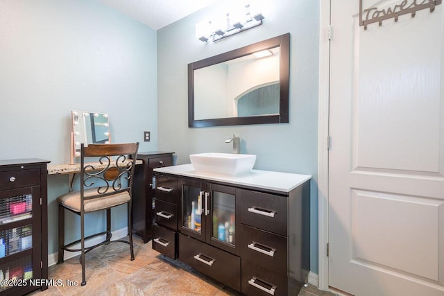 bathroom featuring baseboards and vanity