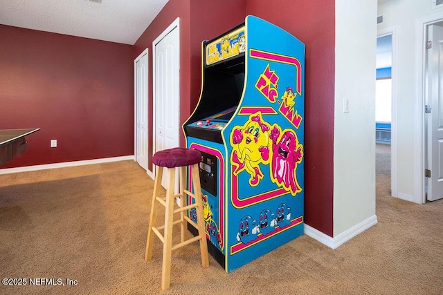 recreation room featuring carpet, visible vents, and baseboards