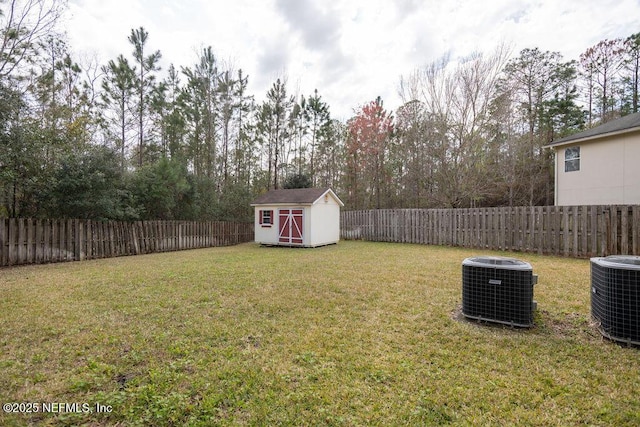 view of yard featuring a fenced backyard, an outdoor structure, a storage shed, and central air condition unit