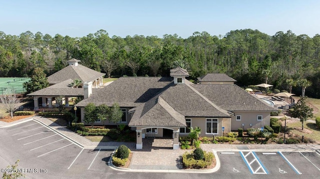 birds eye view of property with a view of trees