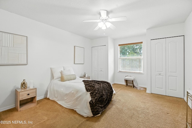 75250 Fern Creek Dr, Yulee, FL 32097 - bedroom with multiple closets, light colored carpet, and a ceiling fan