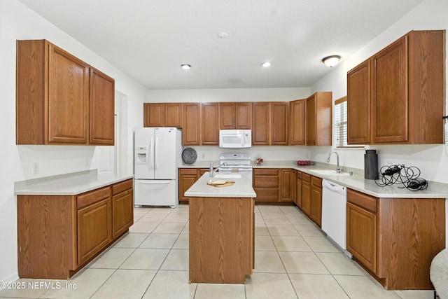 75250 Fern Creek Dr, Yulee, FL 32097 - kitchen featuring white appliances, an island with sink, brown cabinetry, light countertops, and recessed lighting