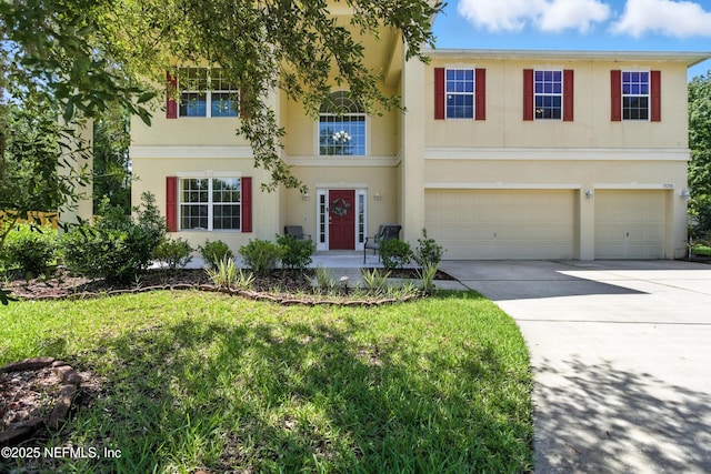 75250 Fern Creek Dr, Yulee, FL 32097 - view of front facade with driveway, an attached garage, and stucco siding