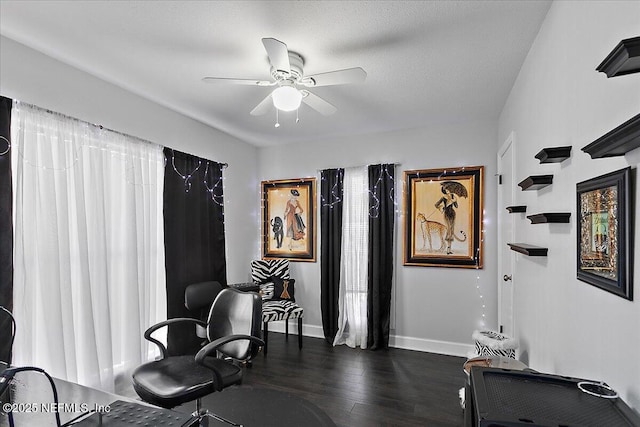 interior space with ceiling fan, dark wood-type flooring, and baseboards