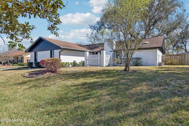 single story home featuring fence and a front lawn