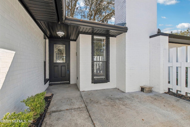 entrance to property with brick siding