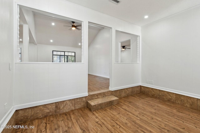 unfurnished room with visible vents, wood finished floors, a ceiling fan, and recessed lighting