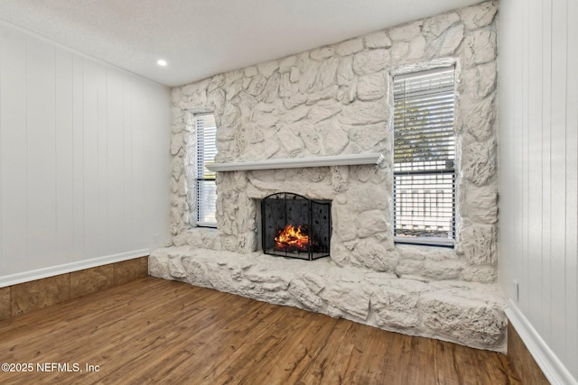 unfurnished living room featuring a fireplace and wood finished floors