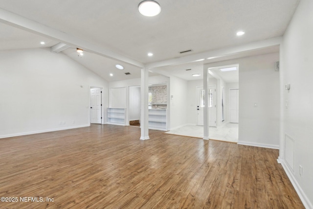 unfurnished living room with lofted ceiling with beams, recessed lighting, visible vents, baseboards, and light wood-style floors